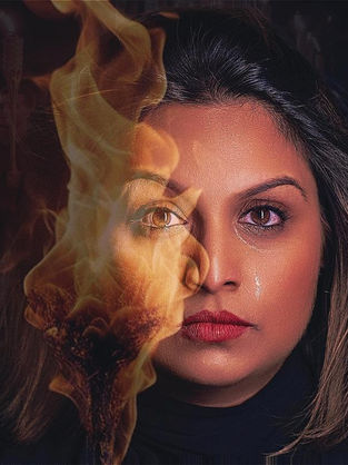 a woman with half her face on fire from a tiki torch