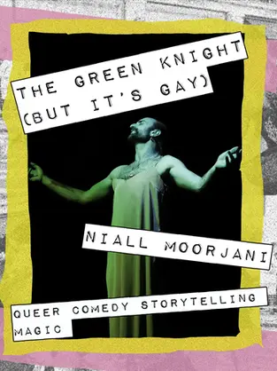 a man washed in green light standing on a stage