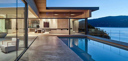 A modern smart home with infinity pool overlooking a lake.