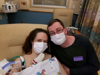 Parents in the NICU holding their premature baby
