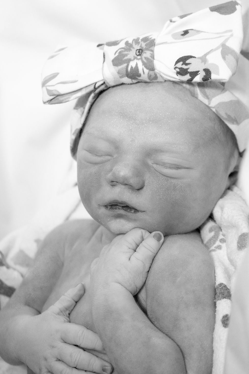 39 week old baby girl born sleeping with a bow in her hair