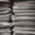 newspapers and books stacked up and looking interesting.jpg