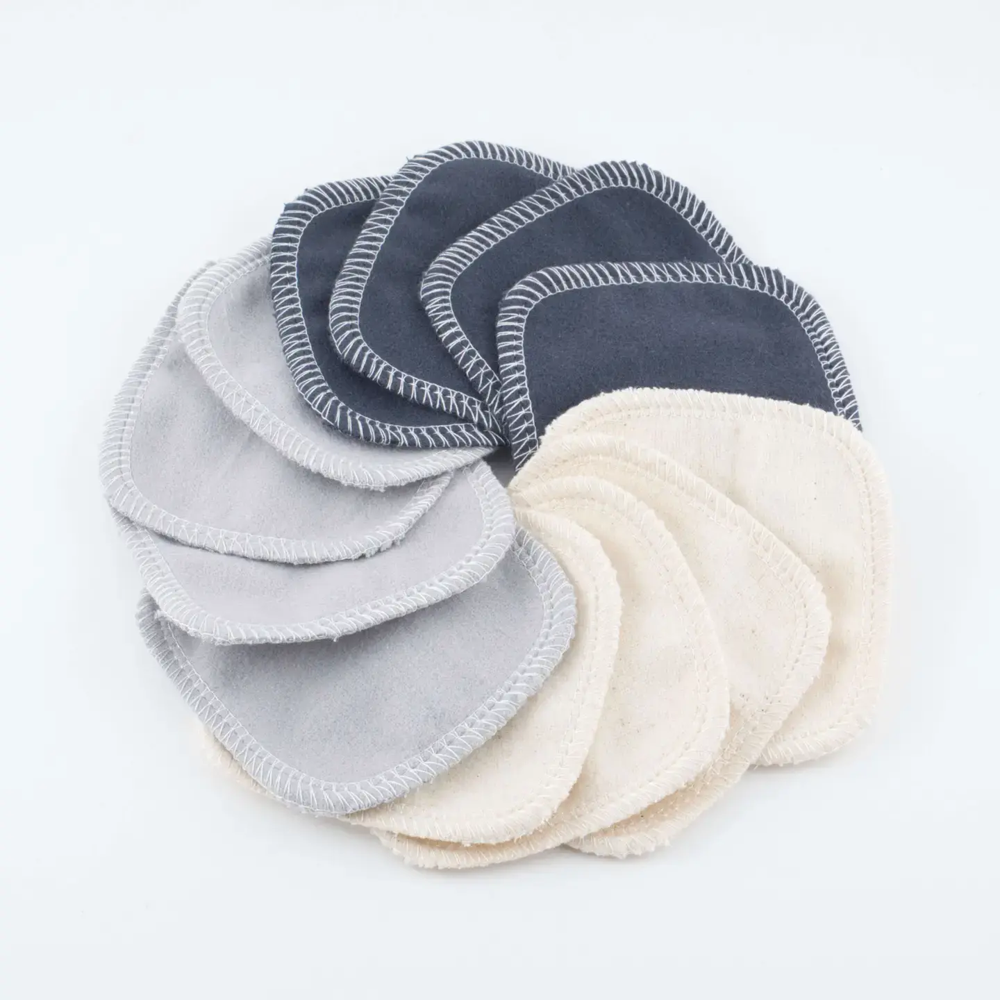 A circular arrangement of reusable cotton pads in dark gray, light gray, and beige. They appear soft and eco-friendly