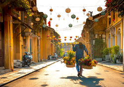 Tourists observing a street vendor in Hoi An Ancient Town during 16-Day Vietnam With Sapa & Phu Quoc