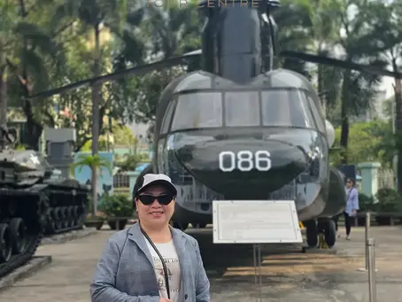flexi tour centre customer stand in front of helicoptor in the war remnants museum Vietnam