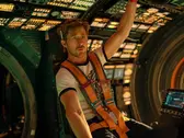 Ryan Gosling inside a futuristic spacecraft in Project Hail Mary, surrounded by glowing control panels and space technology during a tense mission scene.