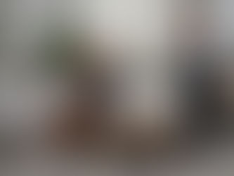 Two young, blonde women in a neutral living space with lots of natural design elements.