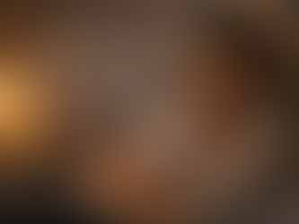 A mom awake at night with a newborn sleeping on her chest peacefully 