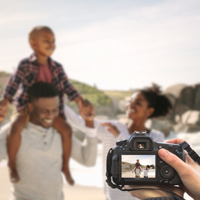 Family on the beach getting pictures while on vacation
