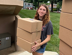 founder carrying boxes of art supplies