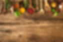 Various colorful herbs and spices on wooden table.jpg