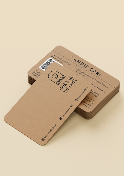 Candle care cards with a black logo and text are on a light beige background.