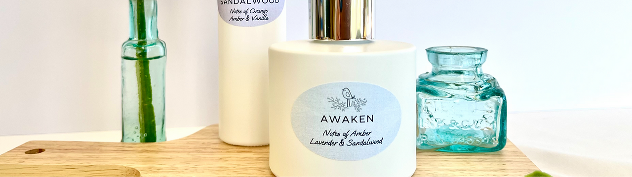 A close-up photo of a white glass diffuser displayed on a wooden board