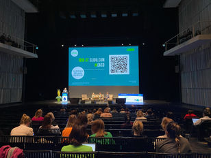 A conference in a large auditorium features a stage with a podium and three seated individuals. A screen displays a QR code for audience participation. The auditorium, with high ceilings and side balconies, suggests a formal professional or academic event.
Tags:
Professional Conference
Q&A Session
Large Auditorium
Audience Engagement
Aventix Services
High Ceilings
Side Balconies
Formal Event
Conference Stage
Interactive Session