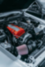 Eye-level view of a performance air intake system installed in an engine bay