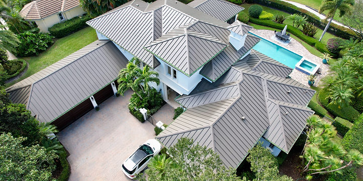 Luxury home in Old Marsh, Palm Beach Gardens, featuring a Medium Bronze standing seam metal roof installed by Legacy Contracting Solutions