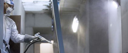 A painter on our paint line, painting a part with power coat paint.