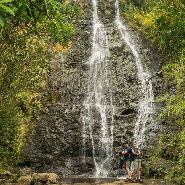 hikers at one of the three waterfalls in Ka'au Crater