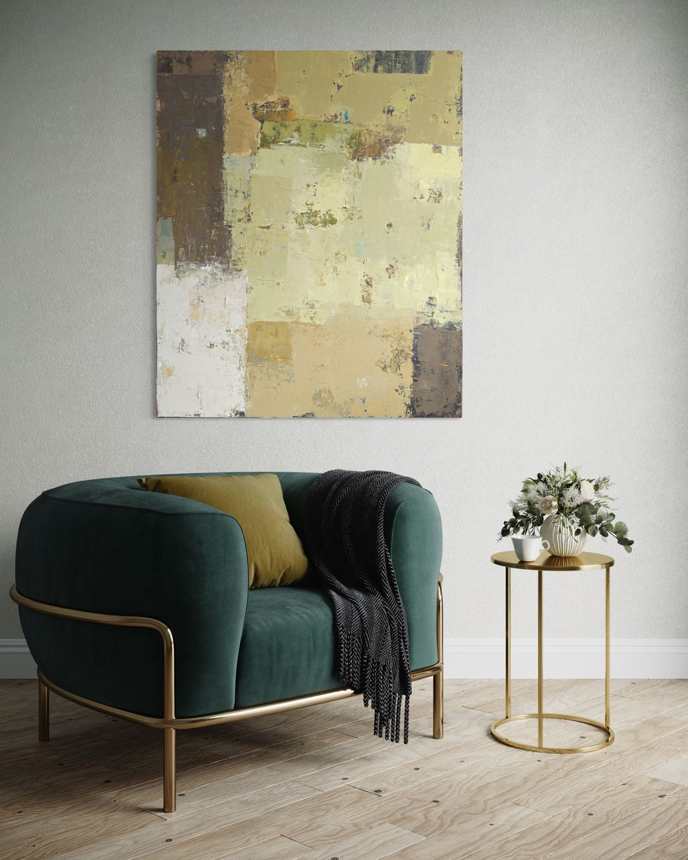 a living room with a green chair and a painting on the wall