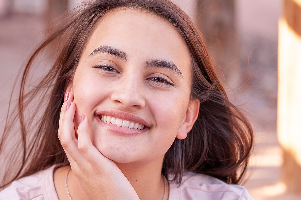 A girl with brown hair smiling