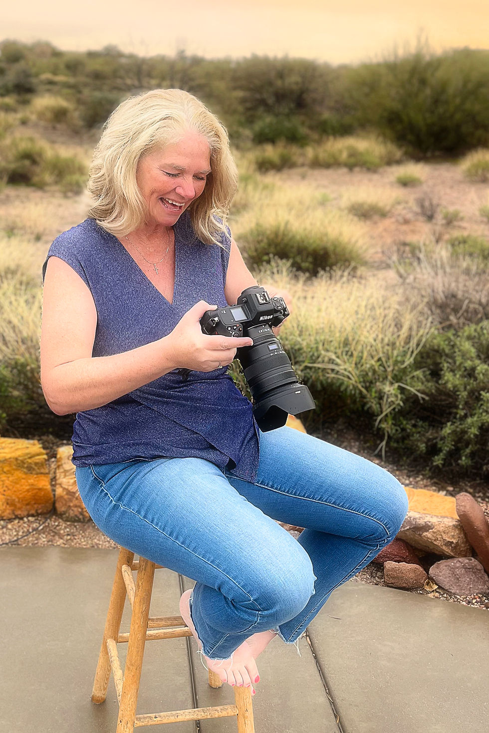 April Foltz, a high school senior portrait photographer smiling at a great shot she just took.