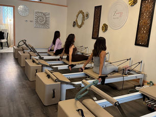 Z3Energy Pilates clients practicing controlled mobility on studio reformers