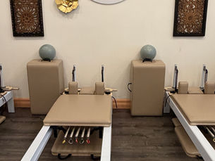 Empty Z3Energy Pilates studio with reformers and studio logo