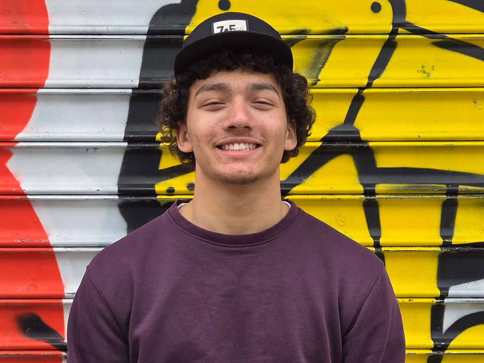 Noah Westry standing in front of mural in NYC