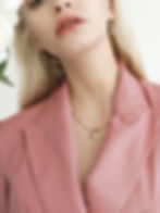 Model wearing bespoke gold heart medallion by Kelly Fletcher Jewelry