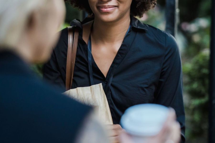 Two women sharing coffee and conversation in a cafe