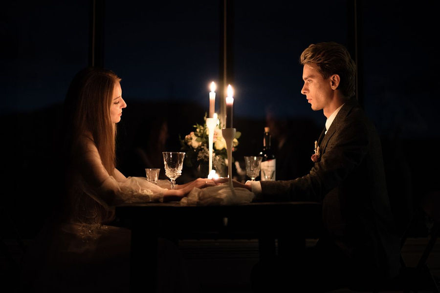 Couple holding hands during a candlelit dinner