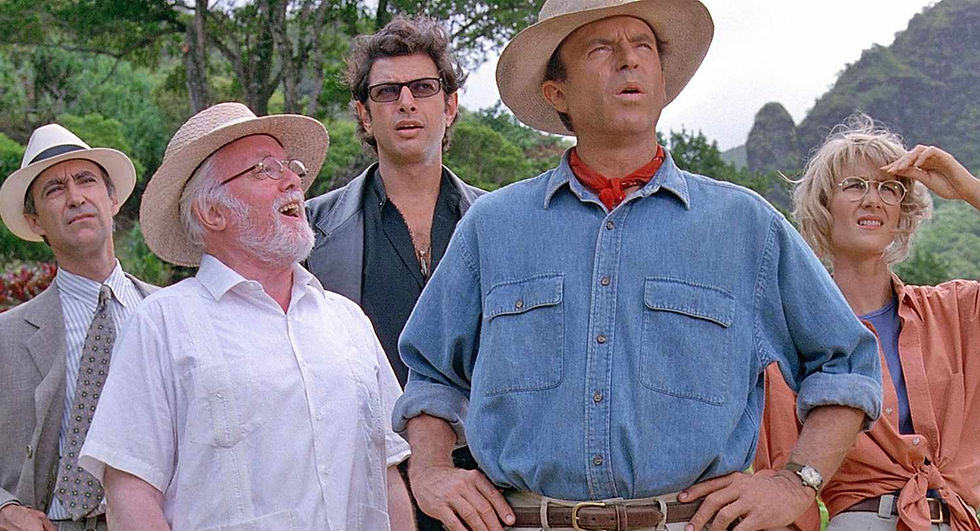 Five people in hats stare upward outdoors in a lush jungle, looking concerned and awestruck.