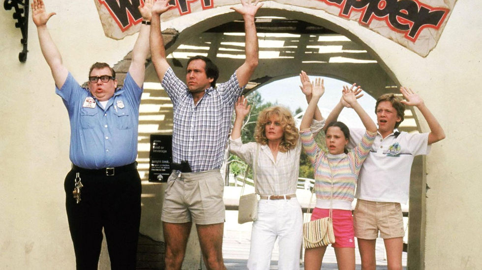 The Griswold family and a security guard with hands up.
