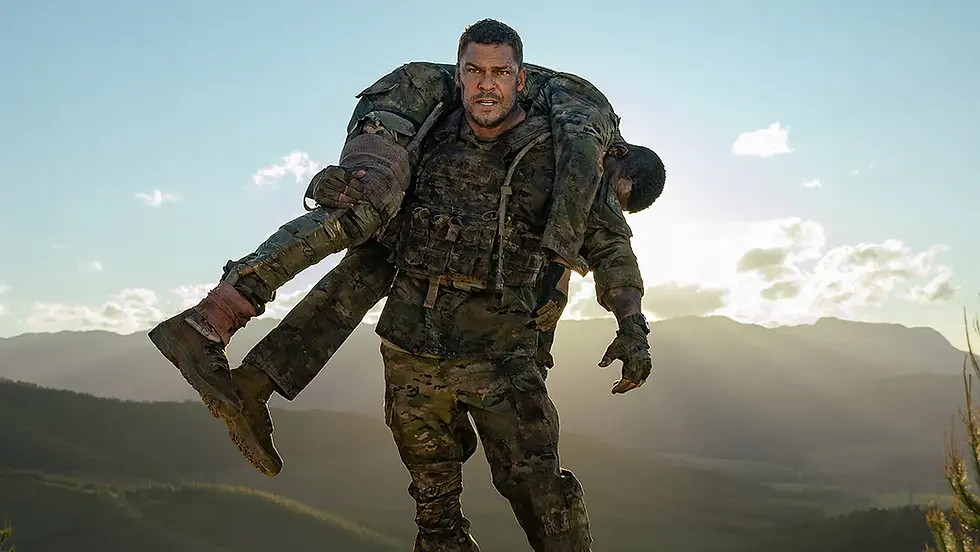 A soldier carries another on his shoulders in a mountainous landscape at sunrise. Both wear camo gear, conveying determination and endurance.