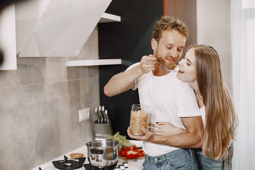 Couple preparing a meal together in a modern kitchen.
