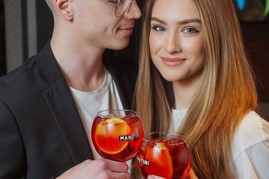 Couple enjoying cocktails together at home
