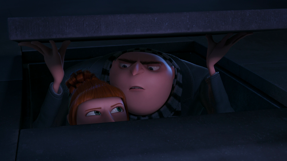 Gru and Lucy peer out from beneath a hatch during their mission.