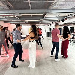 Beginner Bachata and Salsa dance class in Dublin with smiling students learning in pairs
