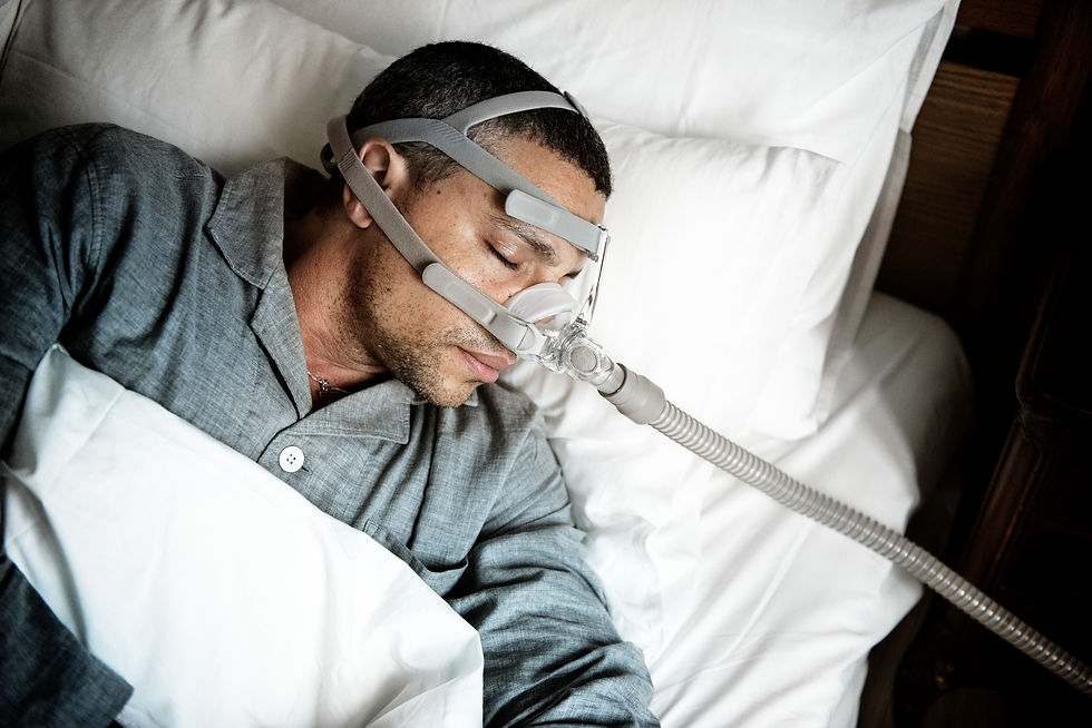 Man wearing CPAP oxygen mask for sleep apnea treatment