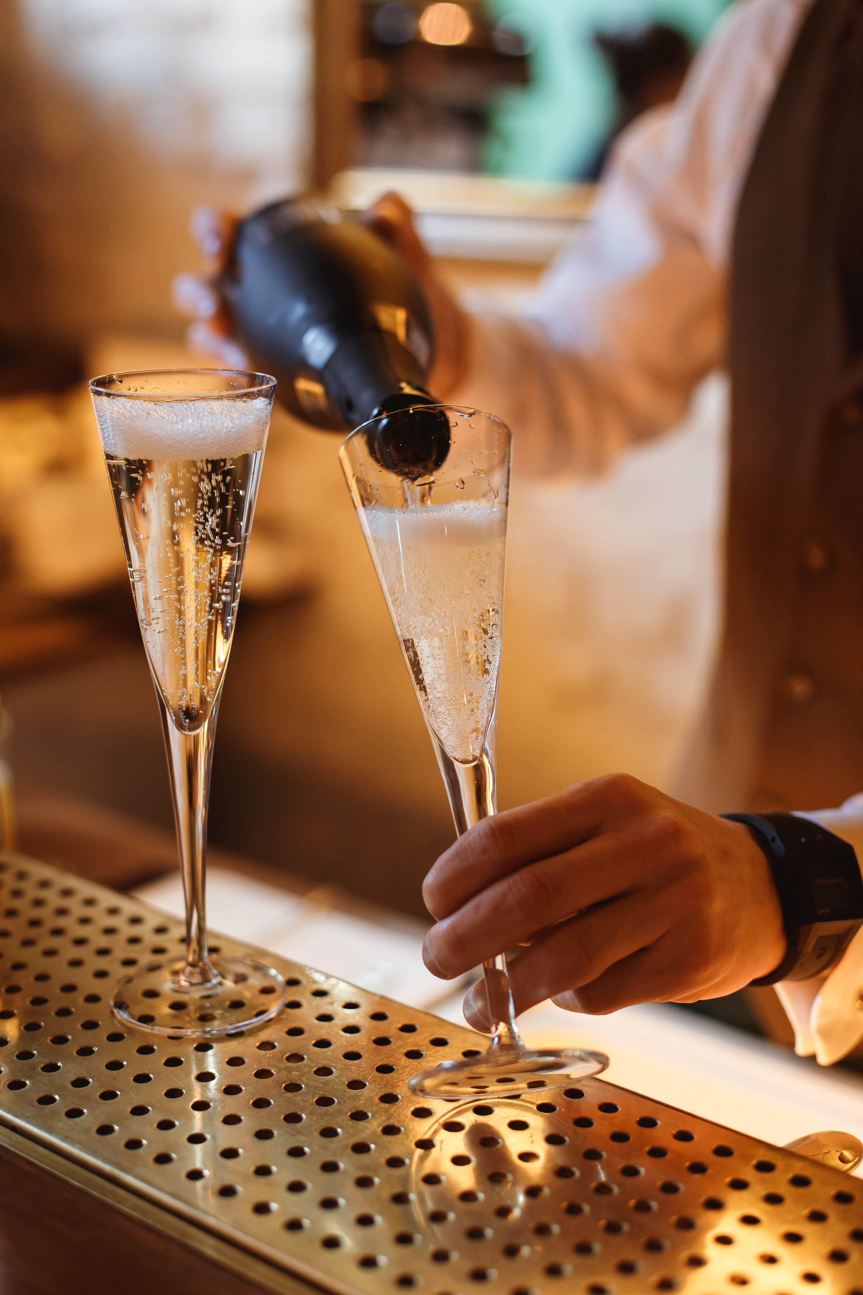 bartender-filling-a-flute-glass-with-sparkling-win-2023-11-27-05-37-24-utc.jpg