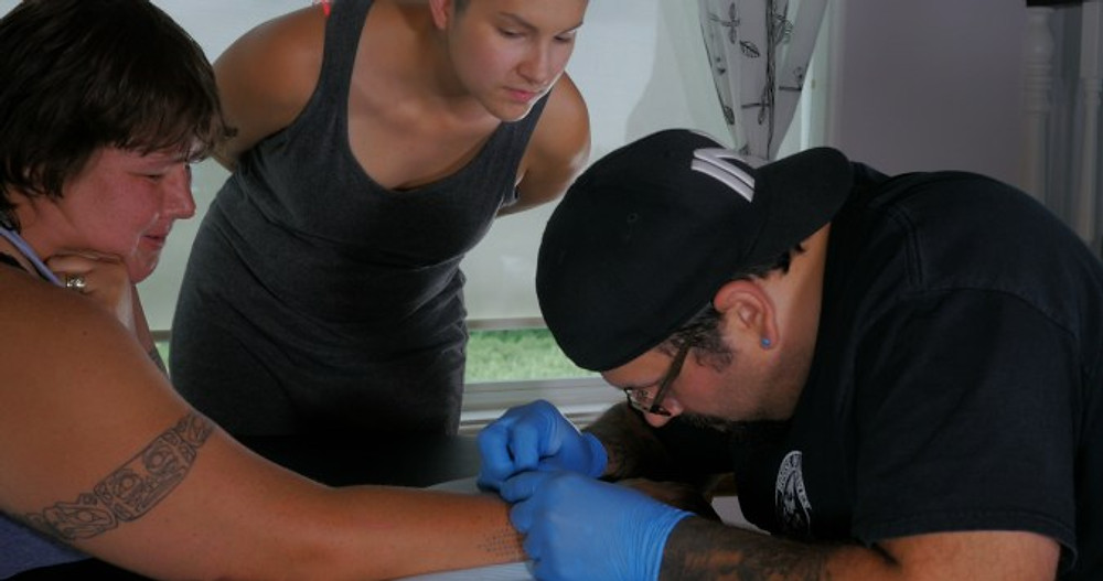 Dion Kaszas Demonstrating Skin Stitch Tattooing