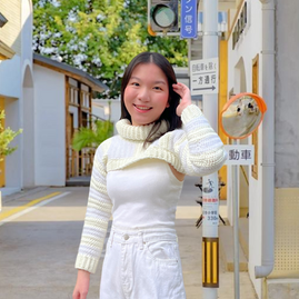 A cream and white striped turtleneck shrug that has mixed yarn textures: fuzzy squirrel yarn and soft milk cotton yarn.