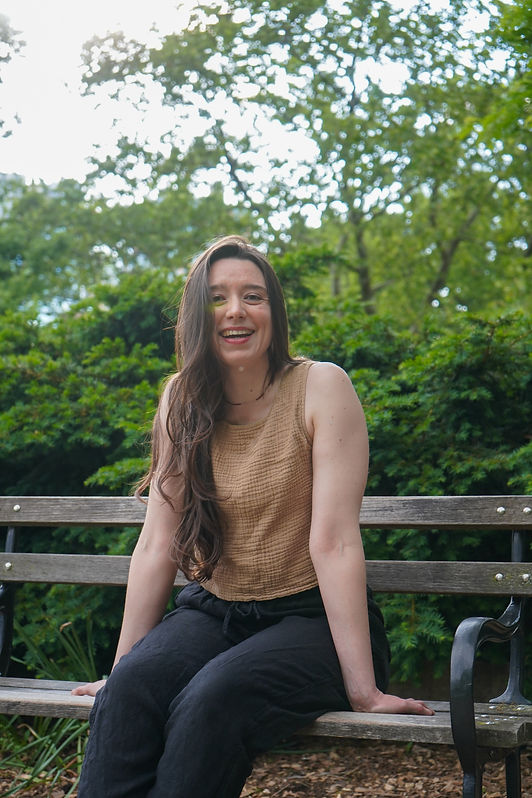 Hanne seated on a bench laughing