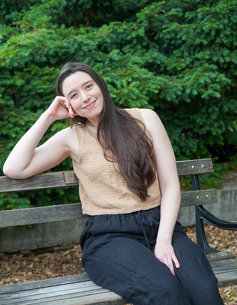 Hanne seated on a park bench