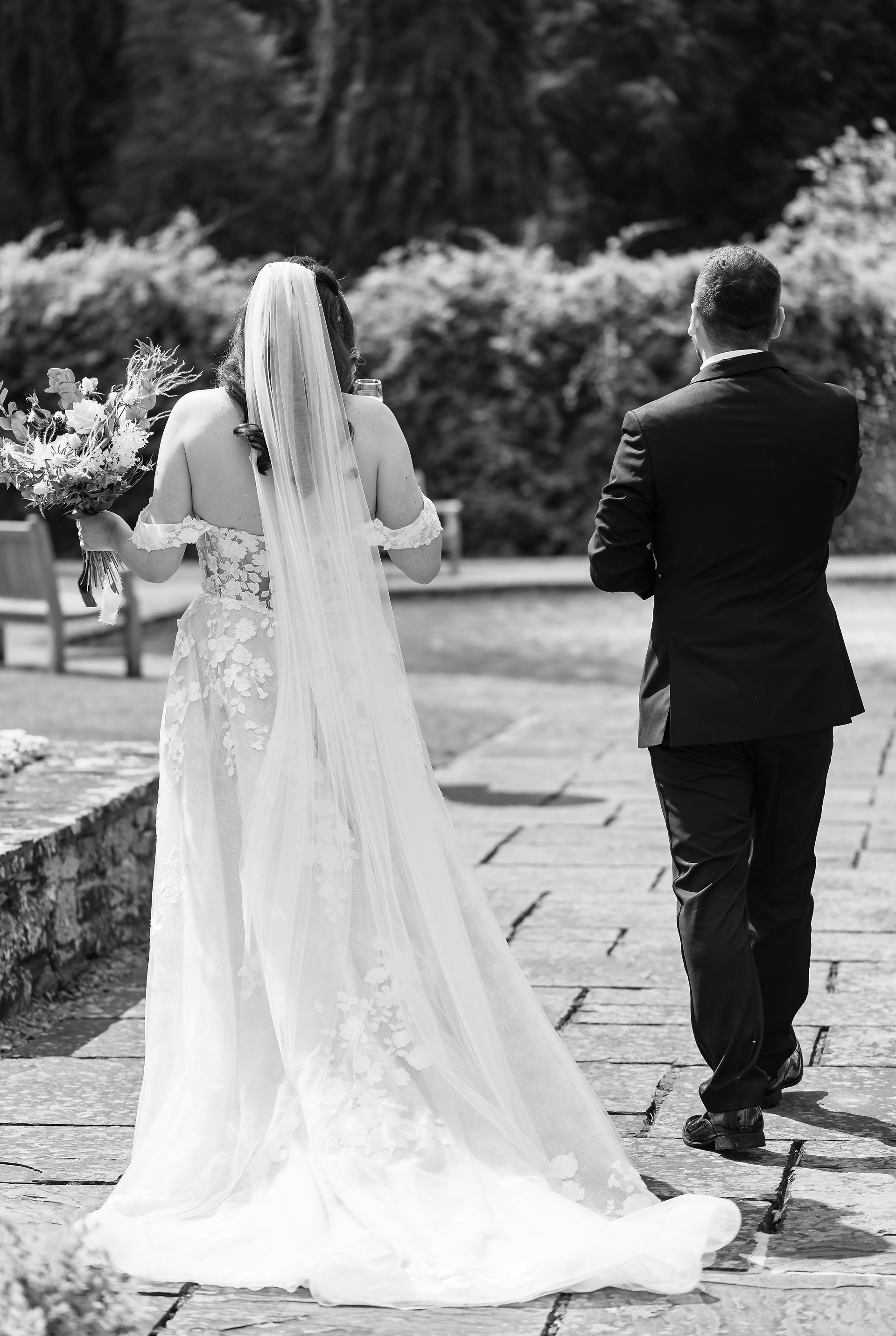 Bride and groom walking away relaxed after ceremony black and white