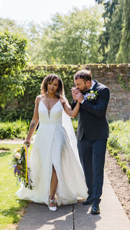 Wedding couple walking and holding hands at Arley House Arboretum in Worcestershire