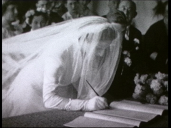 Dora signing wedding papers