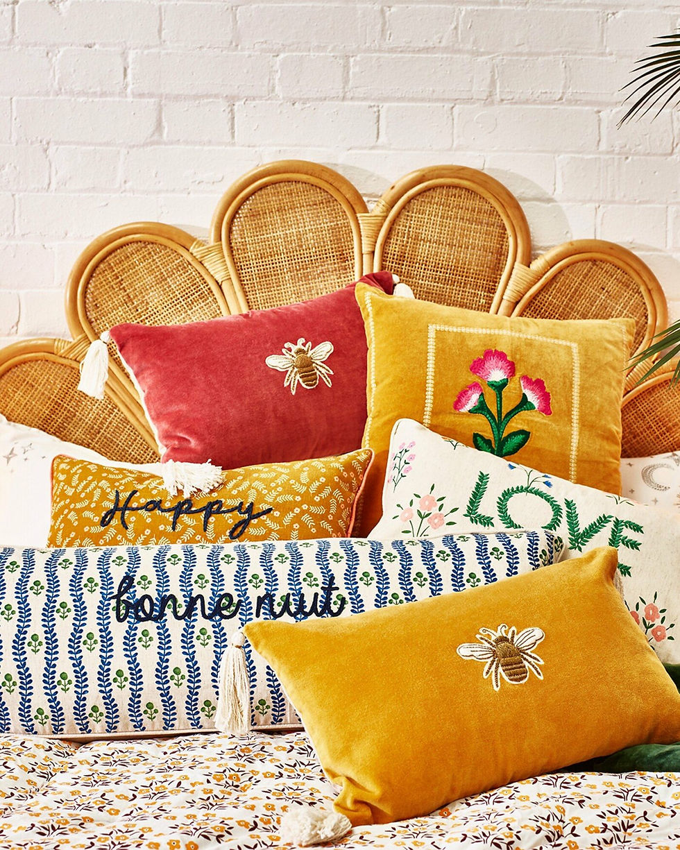 coloured cushions on bed - gifts for uni students