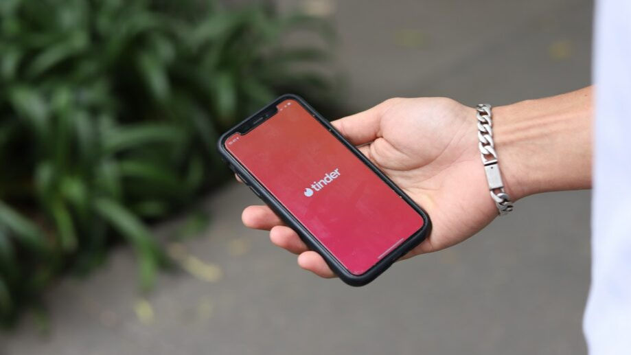 tinder on app on phone in hand