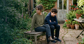 Parent and teenager sitting together at home during the anxious wait for exam results